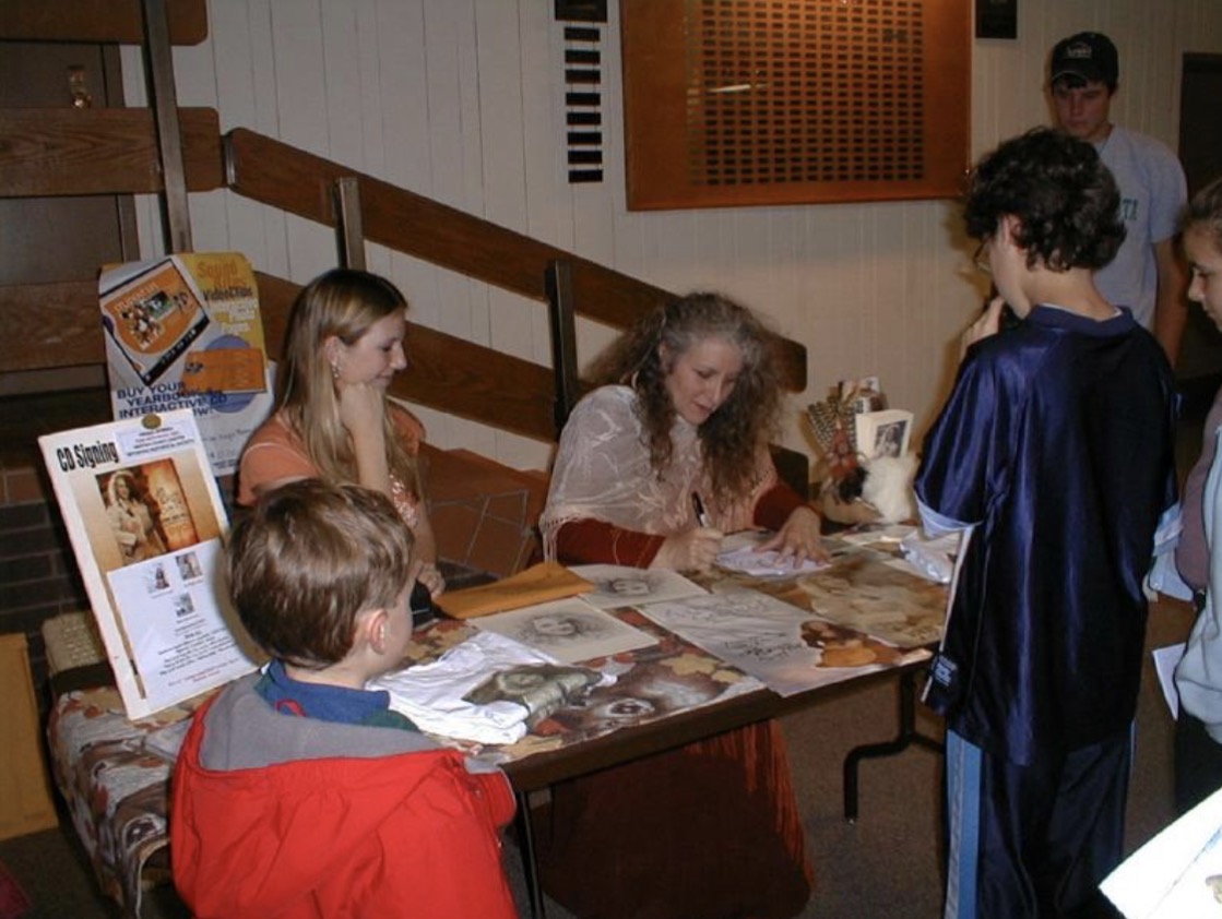 Bunny at a CD signing event with fans and promotional materials